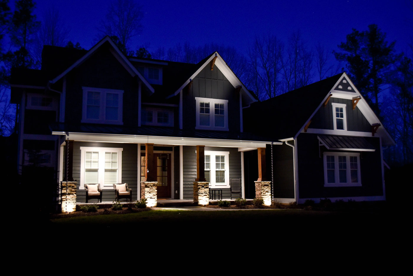 A poorly lit home in need of outdoor lighting service.